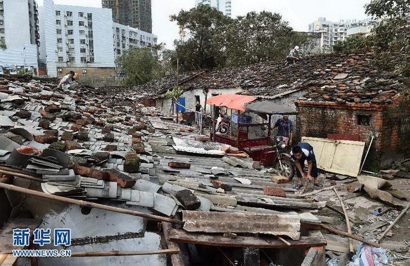 村民在修整被台风吹坏的瓦片。