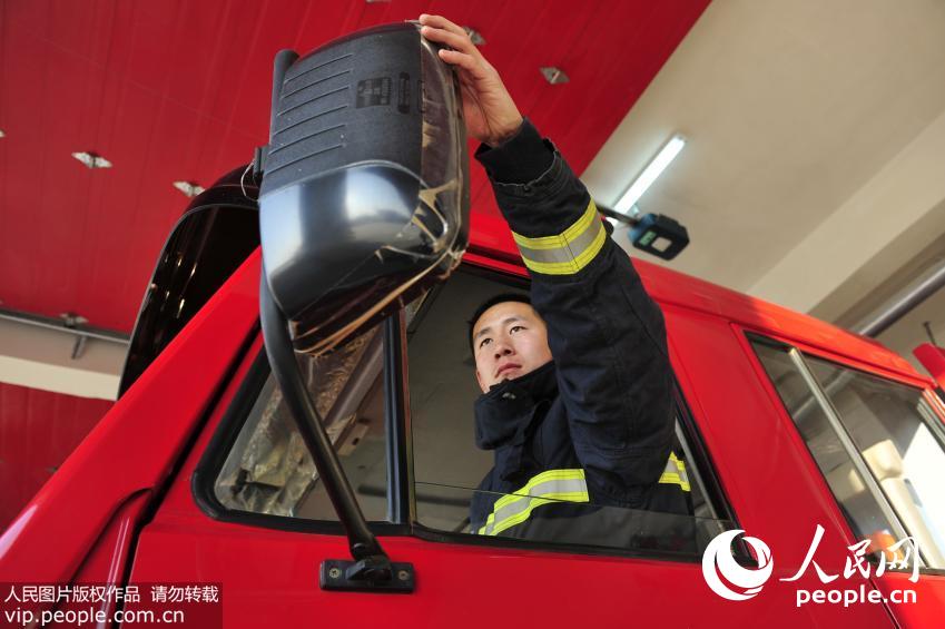 “90后”消防战士王奎东在出火警前调试装备。