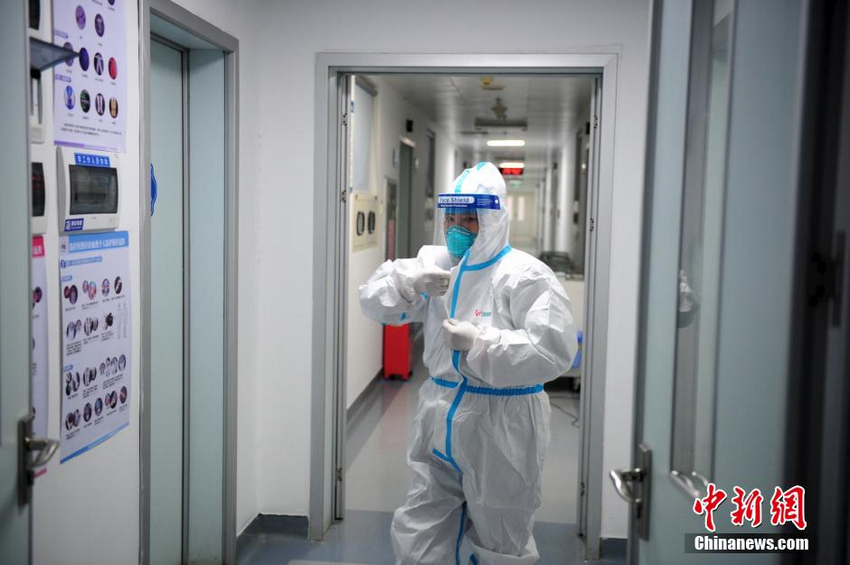 图为感染科医生全副武装走进病房。