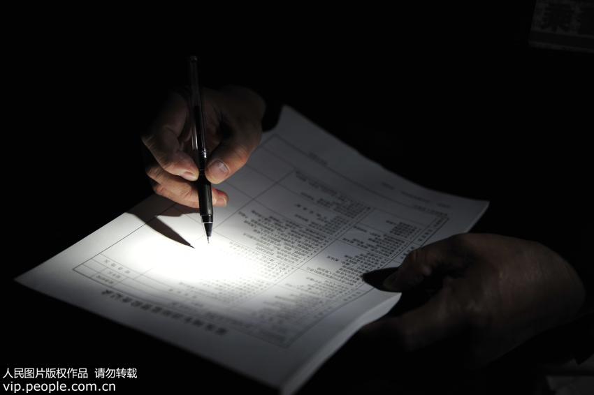 2月16日晚,在呼和浩特开往满洲里的K274次列车上,乘警胡连平同列车工作人员一起检查消防设施后在登记奔上记录检查情况。(声明:凡带有“人民图片”字样图片,系版权图片,受法律保护,使用(含转载)需付费,欢迎致电购买:010-65363647或021-63519288。)
