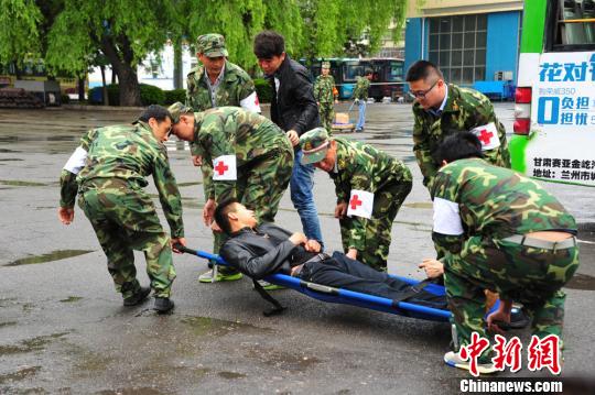 图为演练中,医疗救援组配合120医疗急救人员将受伤人员送往医院救治.