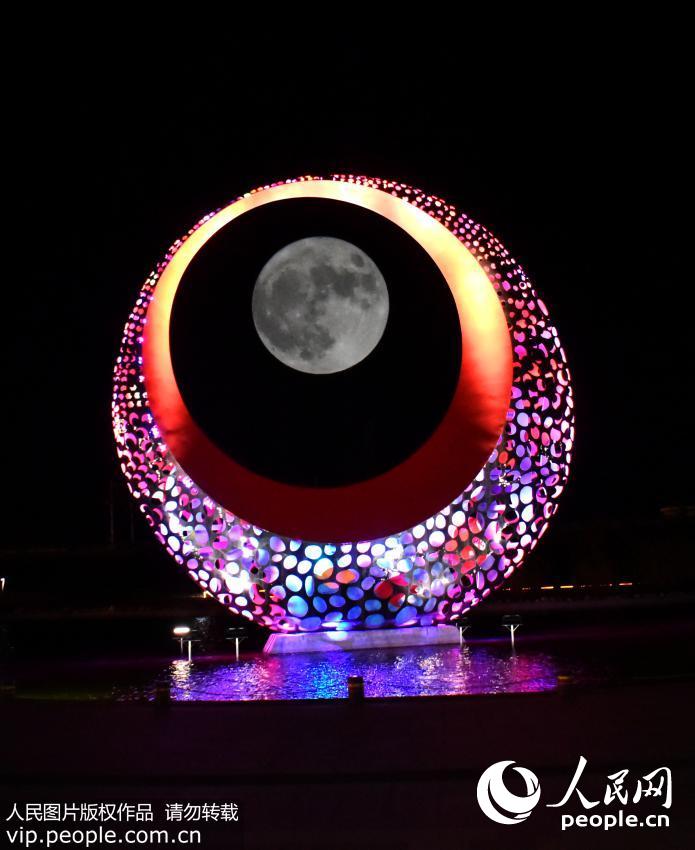 11月14日，在地处山东半岛最东端的滨海小城山东省荣成市，“超级月亮”引来市民驻足观看和拍照。（杨志礼/人民图片）