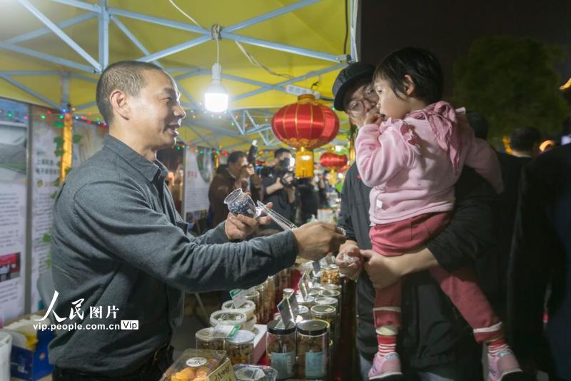 2021年4月28日，上海宝山，市民在智慧湾夜生活节・周末夜市现场品尝扶贫产品。
